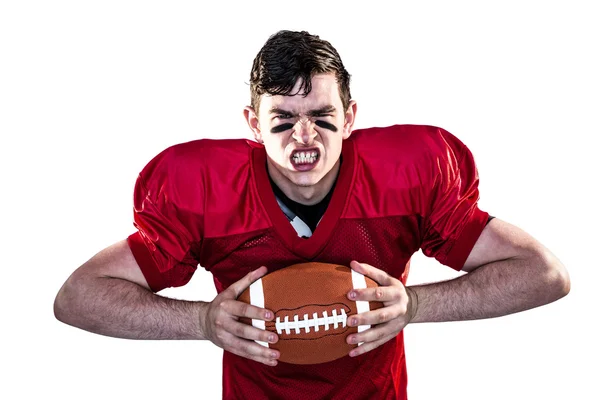 American football player crushing a ball — Stock Photo, Image