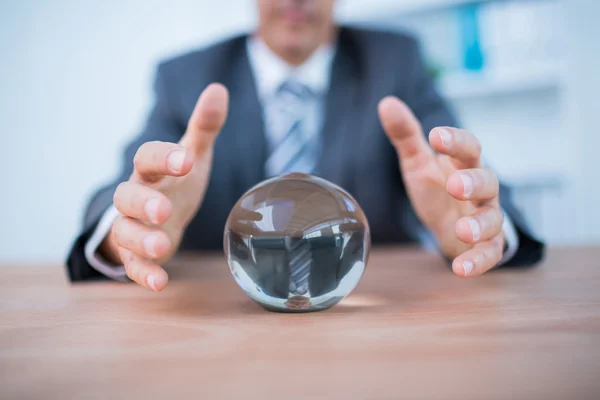 Businessman forecasting a crystal ball — Stock Photo, Image