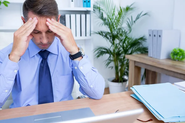 Businessman with severe headache holding his head — Stock Photo, Image