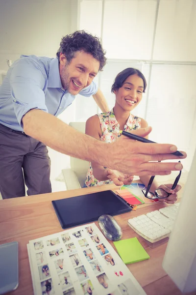 Smiling casual young couple at work — Stock Fotó