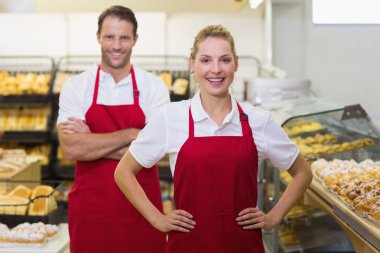 Portrait of two bakers with hands on hips clipart