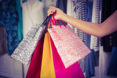 Woman holding shopping bags clipart