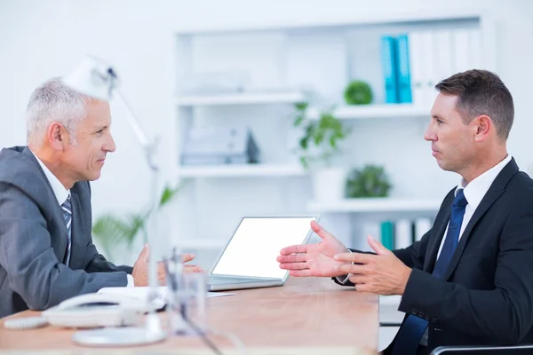 Two serious businessmen speaking and working — Stock Photo, Image