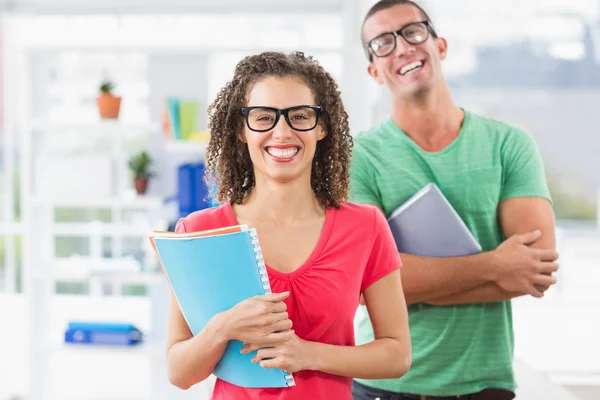 Casual business team looking at tablet and at files — Stock Photo, Image