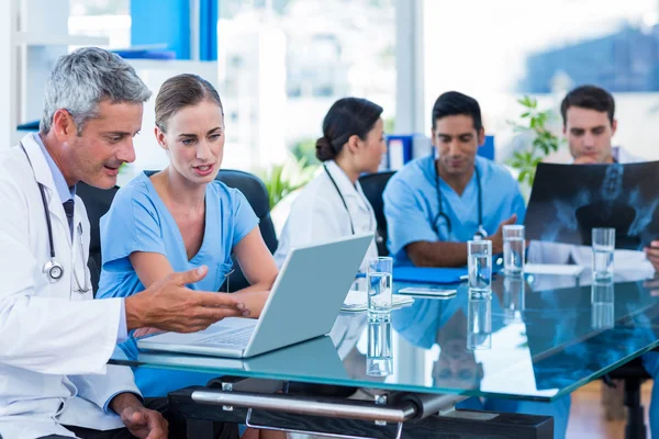 Doctor and nurse looking at laptop — Stock Photo, Image