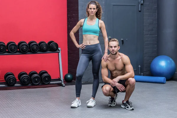 Standing and kneeling muscular couple — Stock Photo, Image