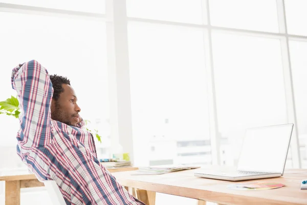 Young businessman relaxing at desk — Stock Photo, Image