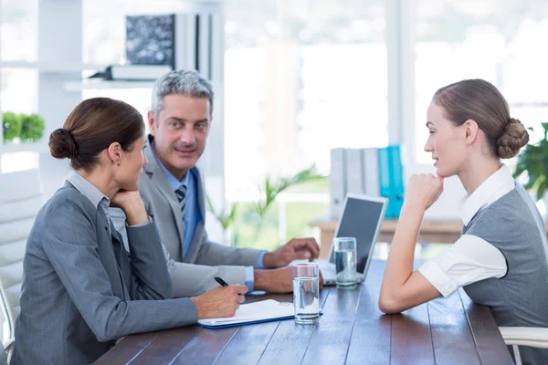 Business people interviewing young businesswoman — Stock Photo, Image
