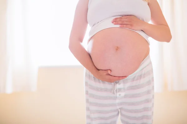 Kobieta w ciąży trzymając jej guz — Zdjęcie stockowe