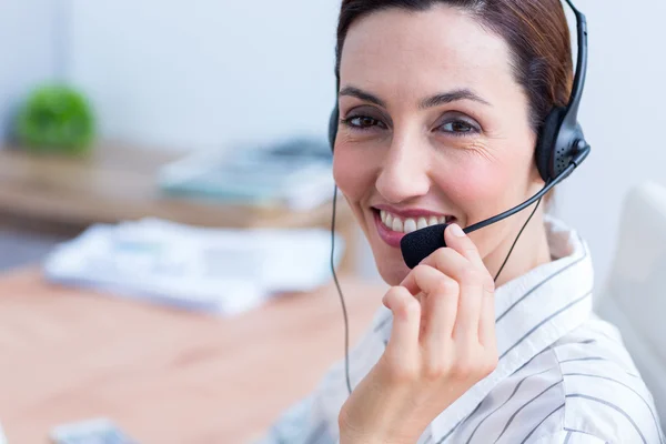 Portrait brunette businesswoman using headphone — Stock Photo, Image