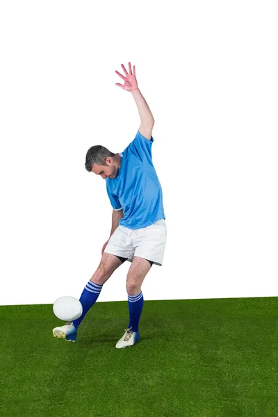 Rugby player kicking a rugby ball — Stock Photo, Image