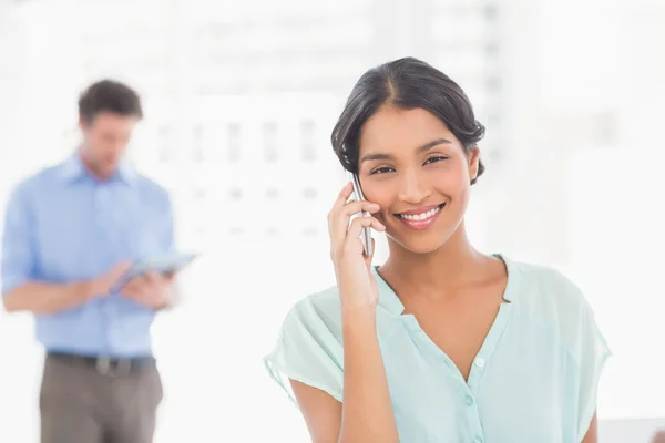 Casual colleagues using digital tablet and telephone — Stockfoto