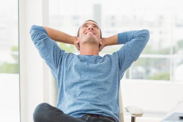 Relaxed creative businessman lying in a chair — Stock Photo, Image