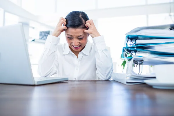 Empresária ficando estressada em sua mesa — Fotografia de Stock