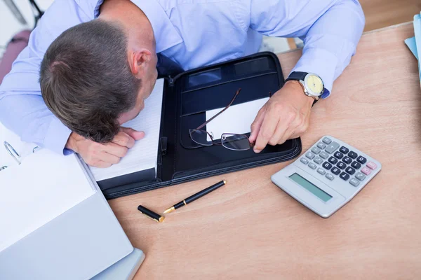 Exhausted businessman sleeping on the desk — Stock Photo, Image