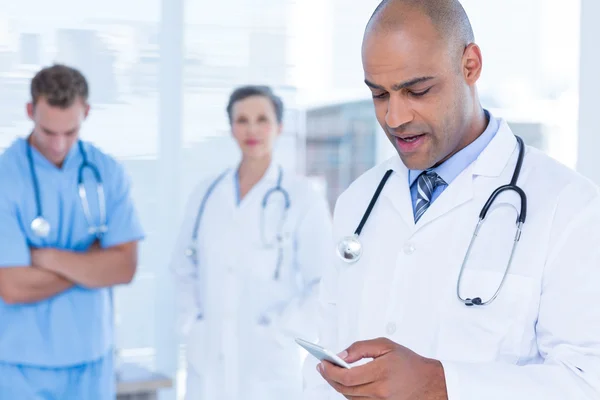 Attentive doctor sending a text message — Stock Photo, Image