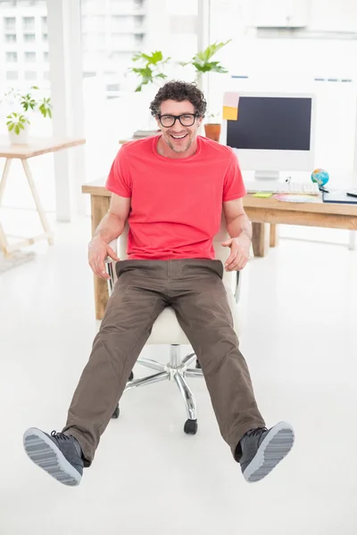 Handsome businessman sitting on a swivel chair — Stock Photo, Image