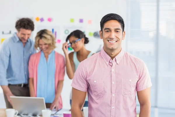 Casual business team having a meeting using laptop — Stock Photo, Image