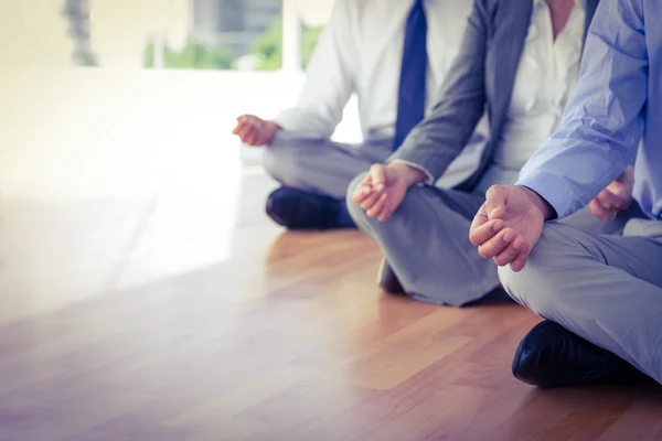 Close up view of business people doing yoga — Stock Photo, Image