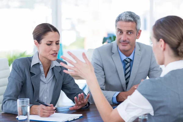 Business people interviewing young businesswoman — Stock Photo, Image