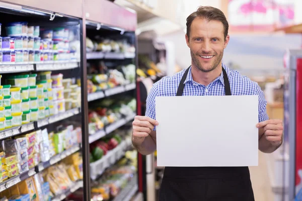 Portrait of a smiling handsome holding a sign — Stock Photo, Image