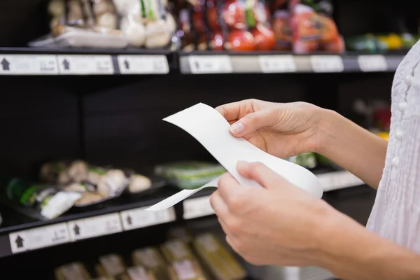 A woman looking at her grocery list — Stock Photo, Image