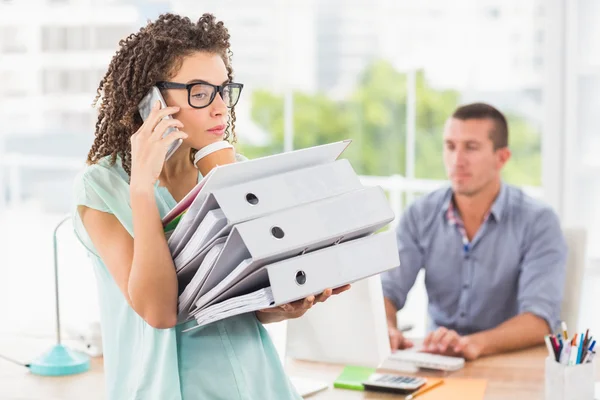 Busy businesswoman carrying a stack of folders — Stock Photo, Image