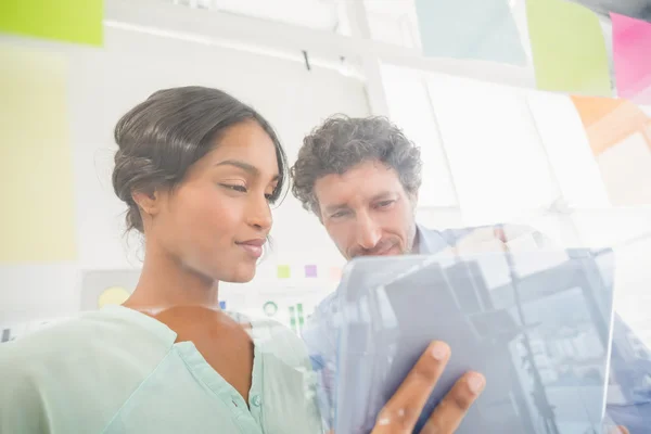 Puzzled business team looking post its on the wall — Stock Photo, Image