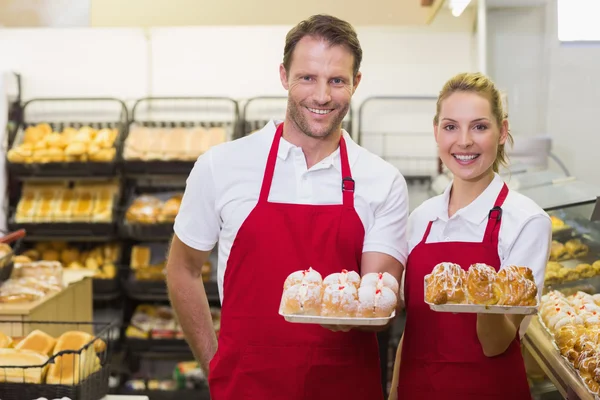 Portrait of smiling bakers having a pastry — Stock Photo, Image