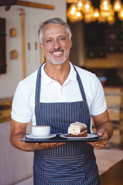 Servitören leende och innehar fack — Stockfoto