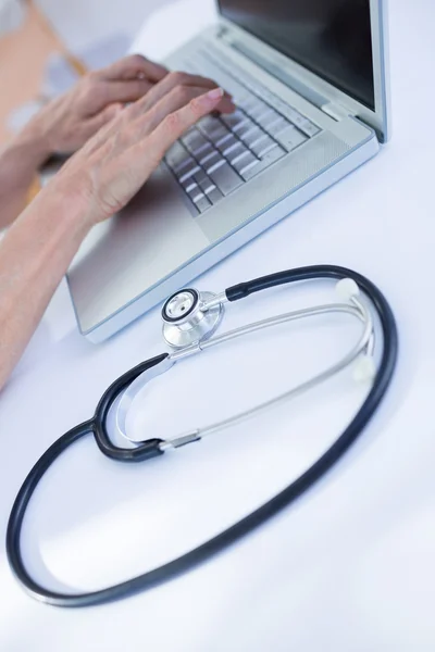 Close up view of female doctor using laptop — Stock Photo, Image