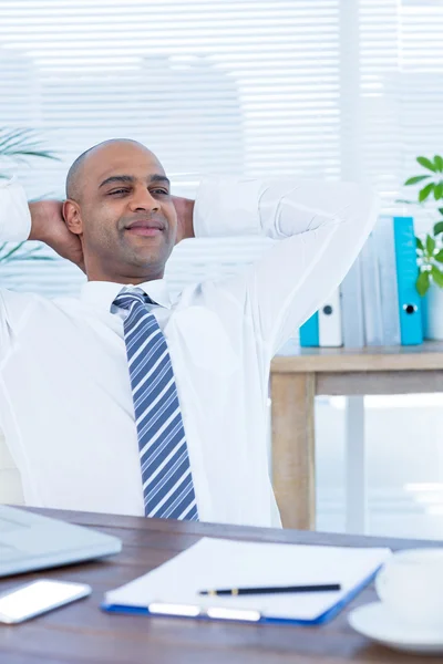 Relaxed businessman lying down in swivel chair — Stock Photo, Image