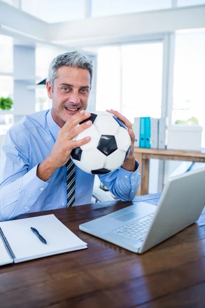 Feliz hombre de negocios sosteniendo balón de pie —  Fotos de Stock