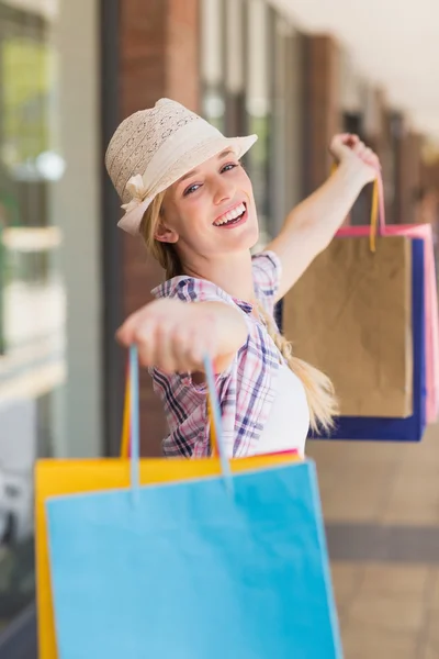 Carefree woman holding shopping bags — Stock Photo, Image