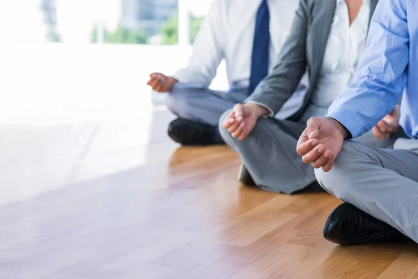 Close up view of business people doing yoga — Stock Photo, Image
