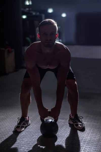 Muskulöser Mann beim Anheben einer Kettlebell — Stockfoto