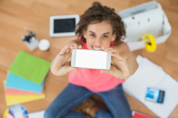 Young creative businesswoman showing her phone — Stock Photo, Image