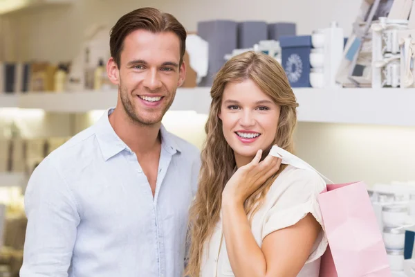 Happy couple smiling in a perfurmery — Stock Photo, Image