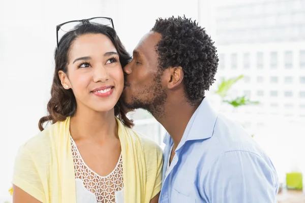 Portrait of a man kissing his colleague — Stock Photo, Image