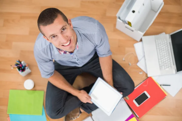 Young creative businessman working on tablet — Stock Photo, Image