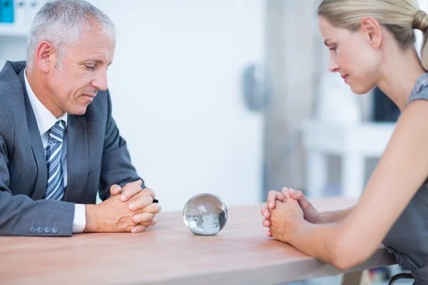 Two business people thinking with a crystal ball — Stock Photo, Image