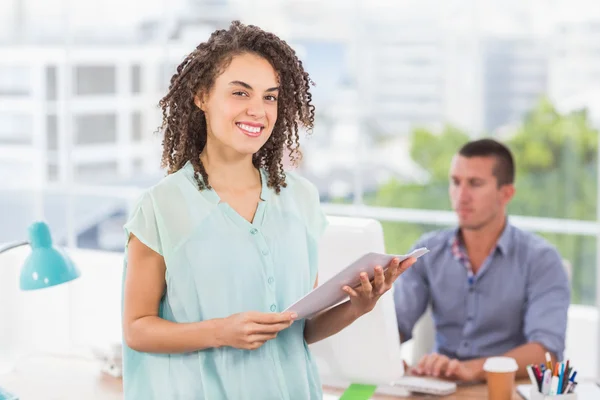 Smiling businesswoman holding a notebook — Stock Photo, Image