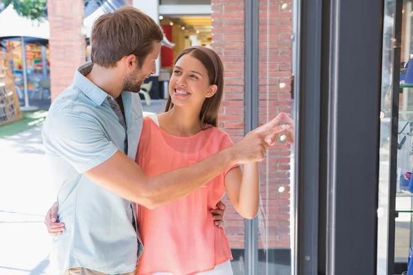 Happy couple looking at window — 스톡 사진