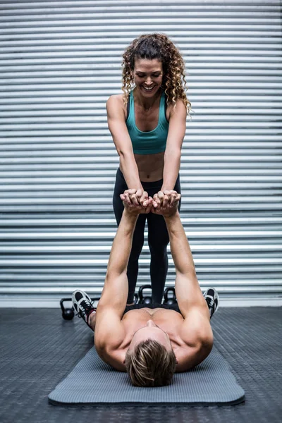 Muscular couple doing core exercises — Stock Photo, Image