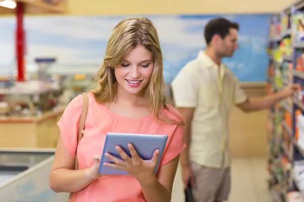 Sorrindo mulher loira bonita usando tablet digital e prod compra — Fotografia de Stock