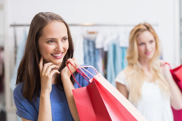 Amigos felices sosteniendo bolsas de compras —  Fotos de Stock