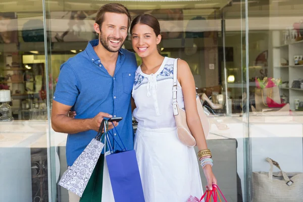 Couple looking at camera after shopping — Stockfoto