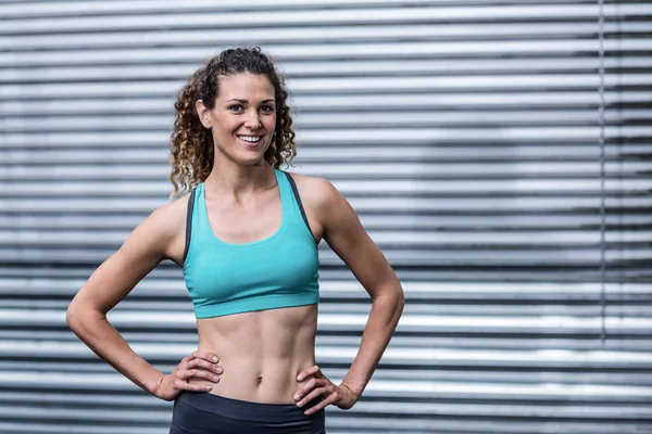 Muscular woman with hands on hips — Stock Photo, Image