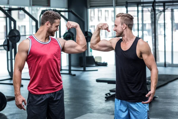 Muscular men flexing biceps — Stock Photo, Image