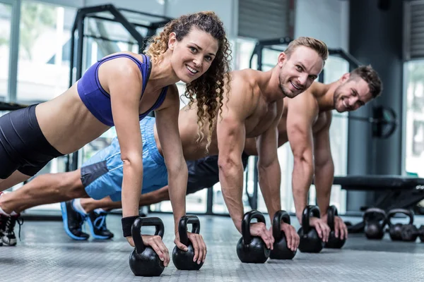 Muscular athletes on plank position — Stock Photo, Image